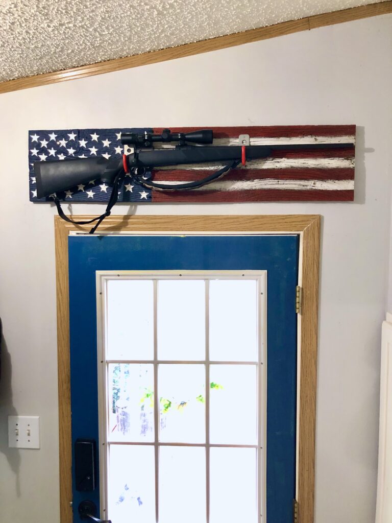 Gun in American flag reclaimed wood gun display